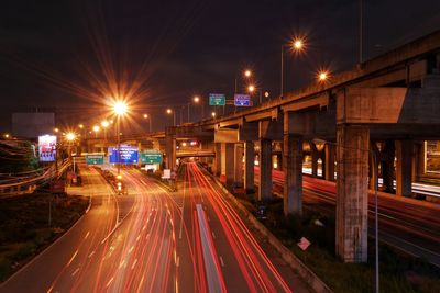 Light trails on road in city at night