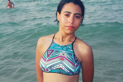 Portrait of beautiful woman standing in sea