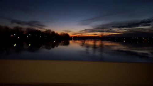 Scenic shot of calm countryside lake at sunset