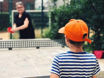 Boy playing table tennis outdoors