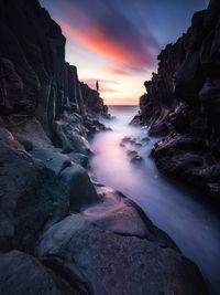 Scenic view of beach against sky during sunset