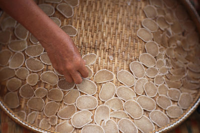 Cropped hand with food on wicker basket