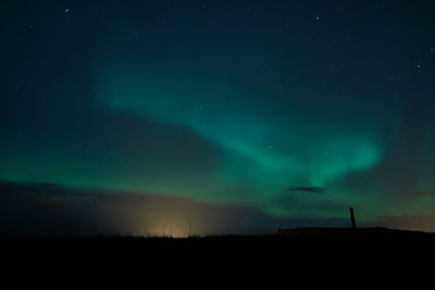 Low angle view of silhouette landscape against sky at night