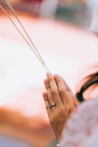 Cropped hand of woman holding plant