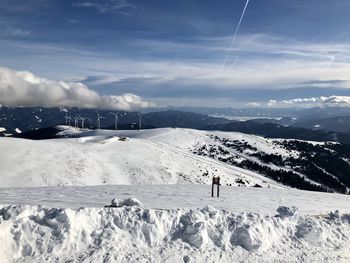 Snow covered landscape against sky