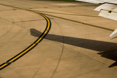 Airplane on airport runway against sky