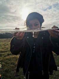 Portrait of teenage girl standing on field