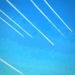 Aerial view of vapor trails in blue sky