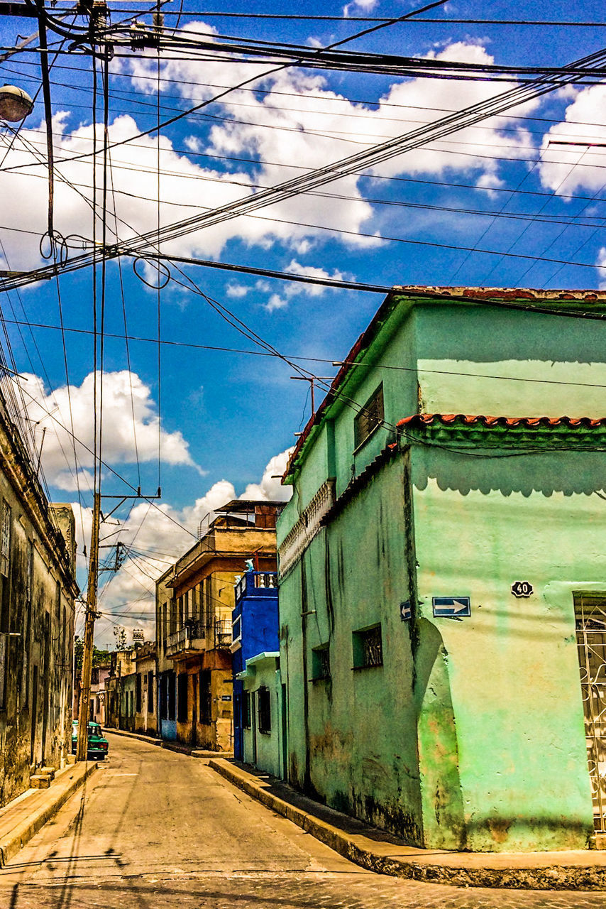 STREET BY BUILDINGS AGAINST SKY