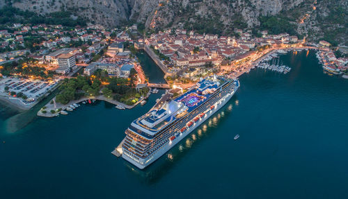 High angle view of cruise ship by cityscape