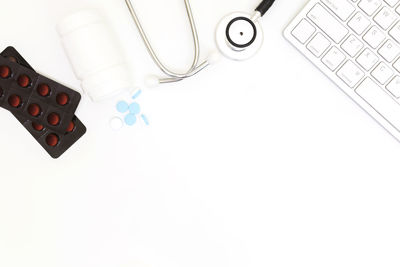 High angle view of computer keyboard on table against white background