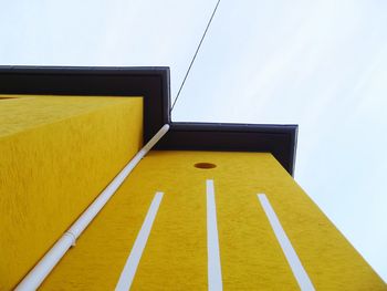 Low angle view of yellow structure against sky