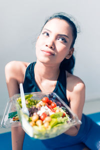 Beautiful woman doing yoga for healthy lifestyle and having a healthy meal.