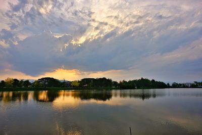 Scenic view of lake against sky at sunset