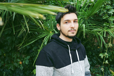 Man standing against plants in town