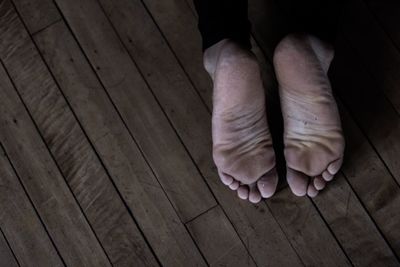 Low section of man on hardwood floor