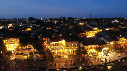 High angle view of illuminated city buildings at night