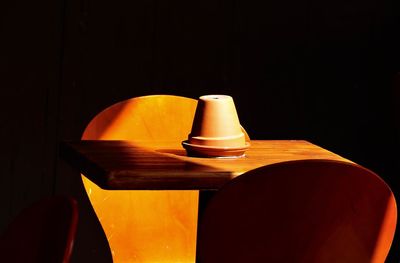 Cropped chairs and table over black background