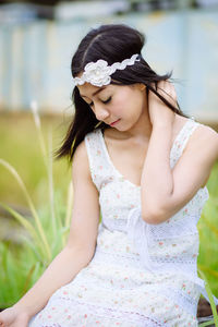 Close-up of a young woman sitting outdoors