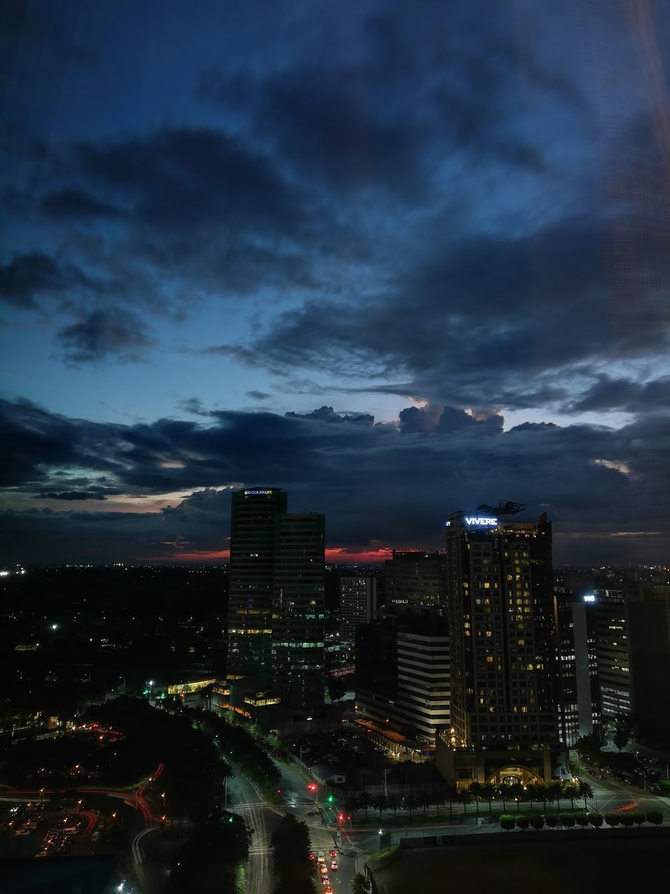 HIGH ANGLE VIEW OF ILLUMINATED BUILDINGS AT NIGHT