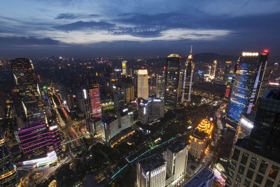 High angle view of illuminated cityscape against sky at night