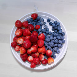High angle view of strawberries in bowl on table