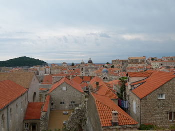 View of townscape against cloudy sky