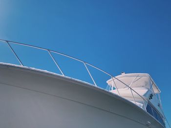 Low angle view of ship against clear blue sky