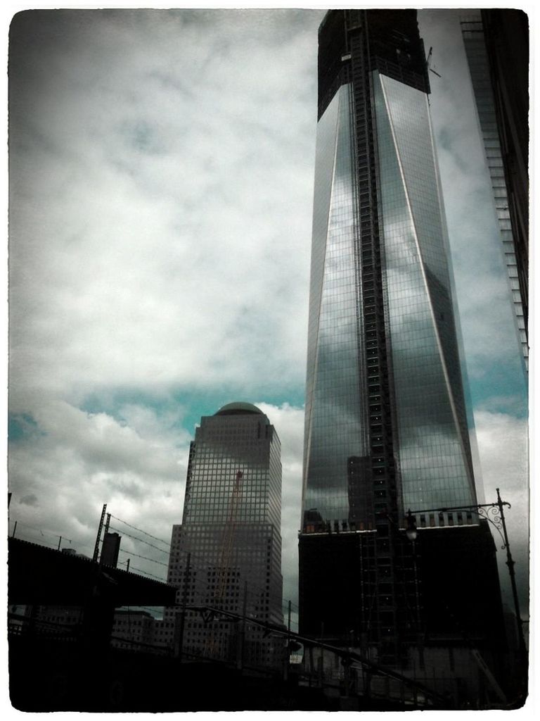 architecture, built structure, building exterior, skyscraper, city, modern, low angle view, tall - high, office building, sky, tower, transfer print, cloud - sky, auto post production filter, building, tall, glass - material, capital cities, city life, development