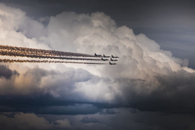 Low angle view of airplane flying against sky