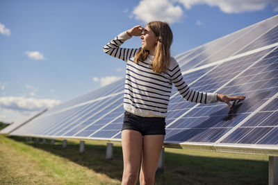 Girl standing next to solar panels