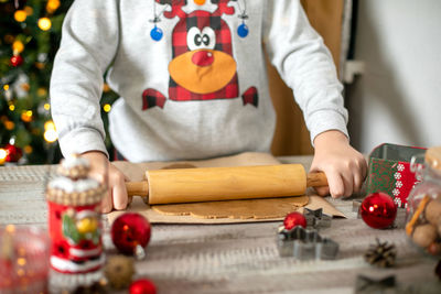 Female hand's preparing christmas cookies food on table