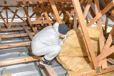 Rear view of man working at construction site