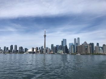 Modern buildings in city against cloudy sky