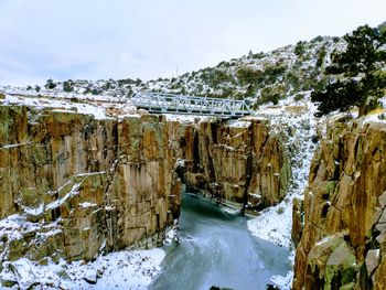 Scenic view of frozen river against sky