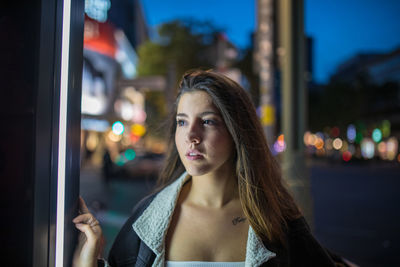 Beautiful young woman at night