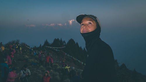 Man looking against mountains at night