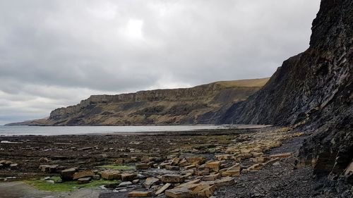 Scenic view of sea and mountains against sky