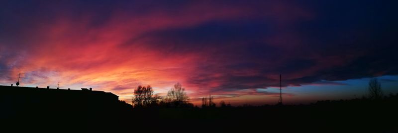 Silhouette landscape against sky at sunset