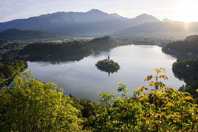 Scenic view of lake and mountains against sky