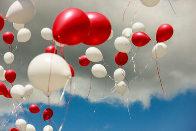 Low angle view of balloons against sky