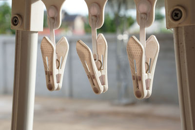 Close-up of hand hanging on clothesline