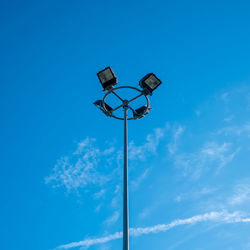 Low angle view of street light against blue sky