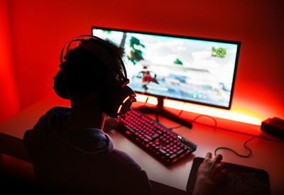 Side view of woman using laptop at home