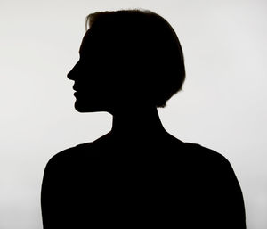 Close-up portrait of silhouette man against white background