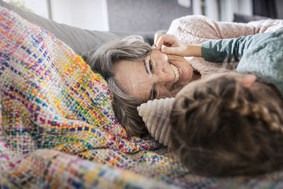 Midsection of couple relaxing on bed