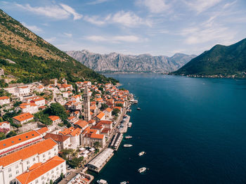 High angle view of townscape by sea against sky