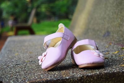 Close-up of shoes on rock