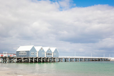 Pier over sea and buildings against sky