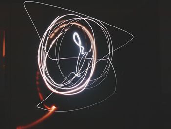 Low angle view of illuminated lamp against sky at night